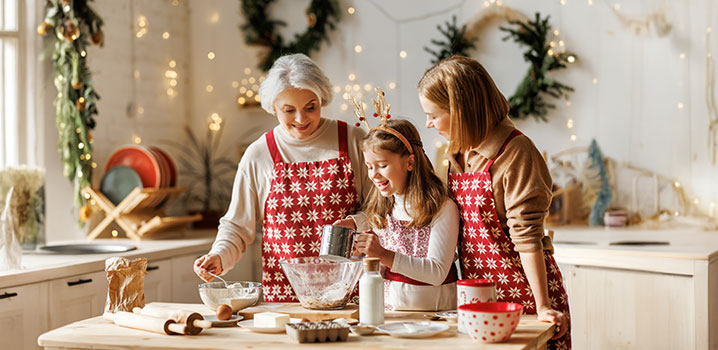 Mädchen bäckt mit Mutter und Großmutter Weihnachtskekse